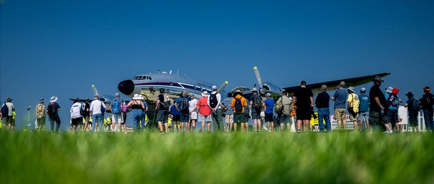 A crowd gathered at EAA to look at an airplane.